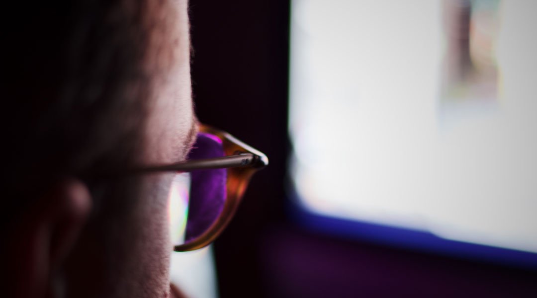 Man wearing blue light glasses to prevent digital eye strain