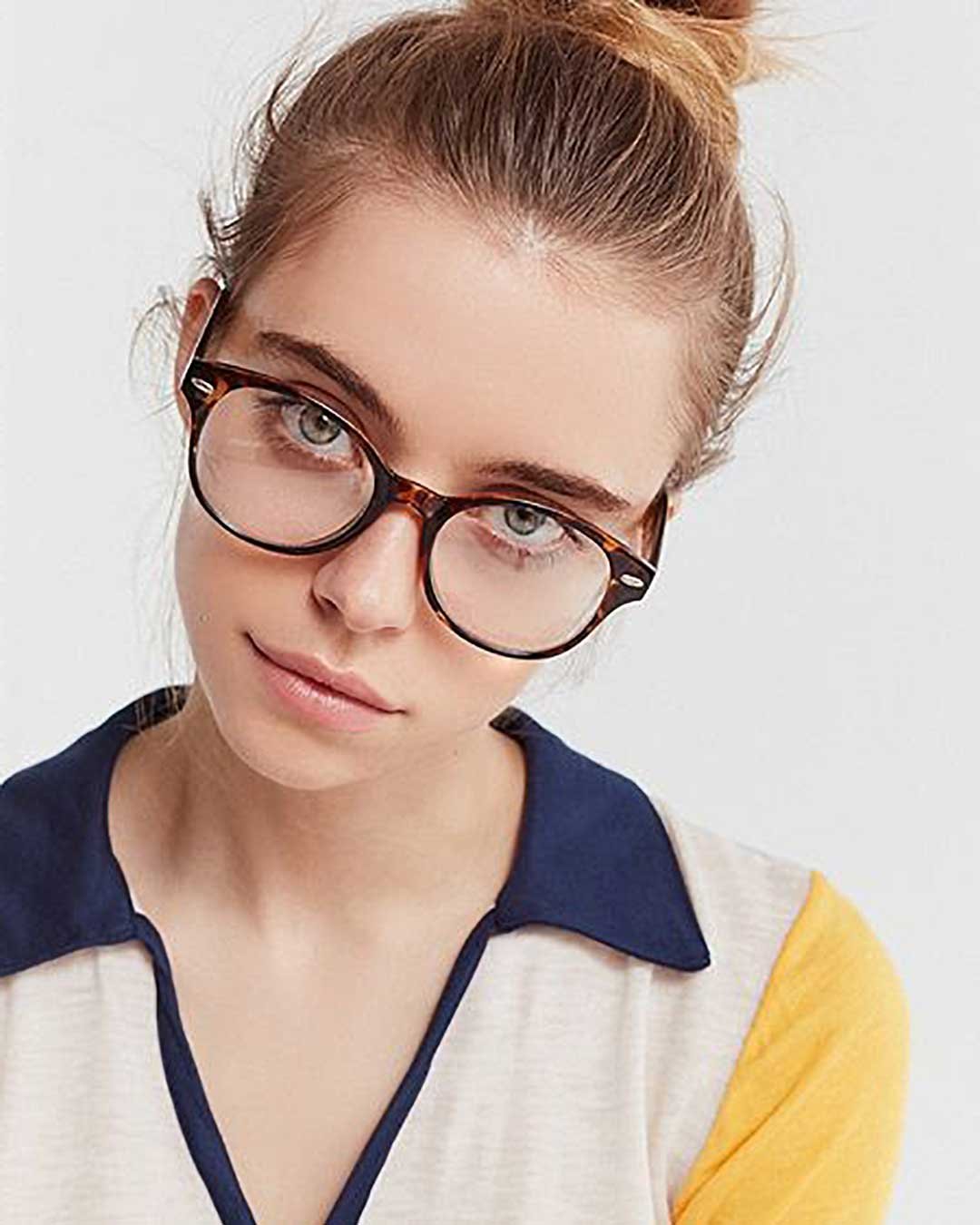 Blonde woman wearing tortoise Wayfarer spectacle frame