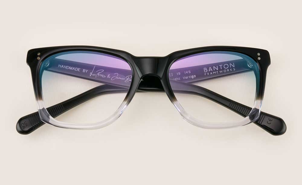 Dual tone black and crystal thick rimmed glasses frame lying folded