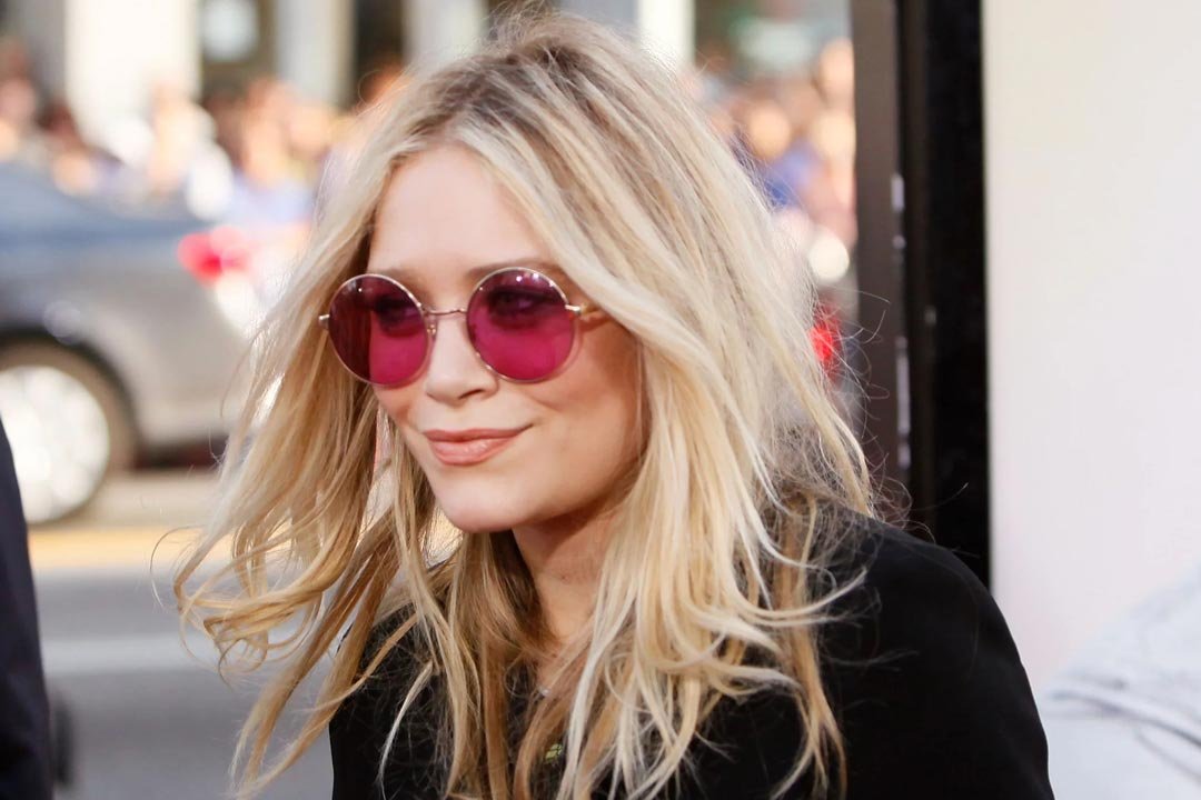Mary Kate Ohlsen in street wearing round wire eyeglasses with pink tinted lenses