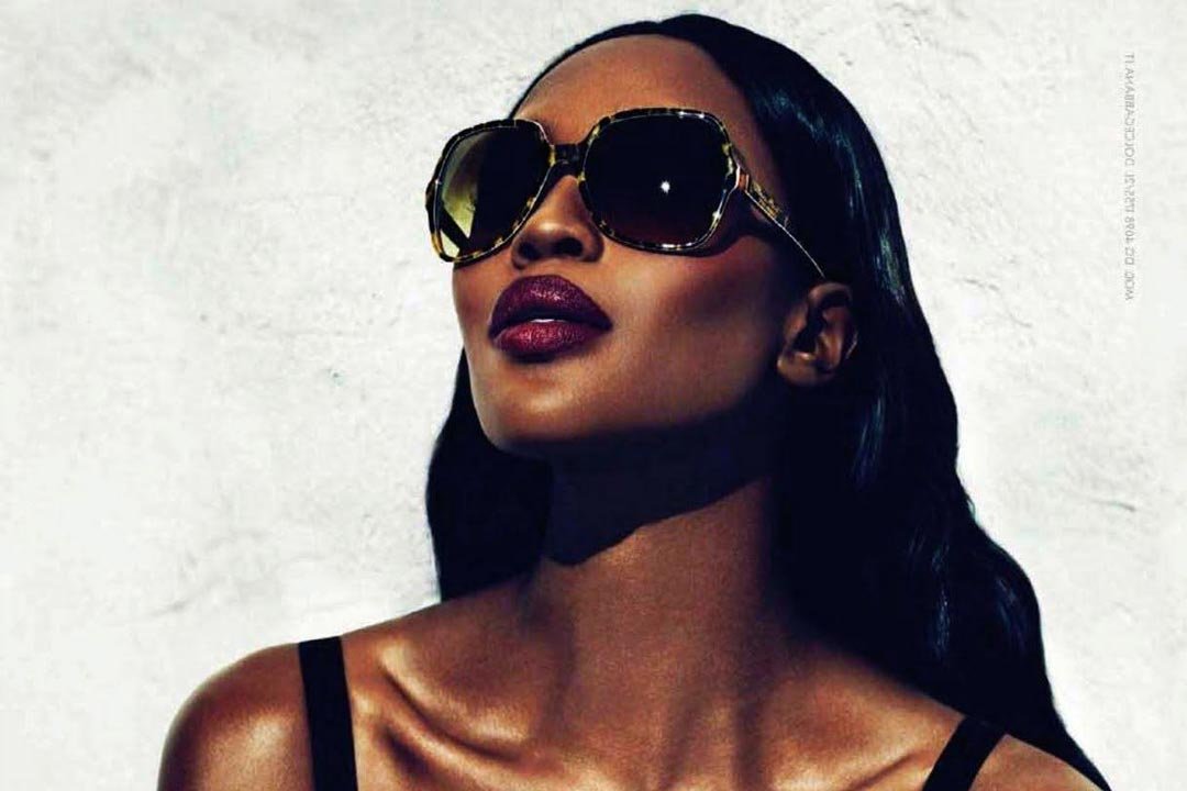 Naomi Campbell wearing large butterfly tortoise sunglasses looking upwards